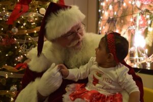 Young girl's 1st Christmas with Santa Dale